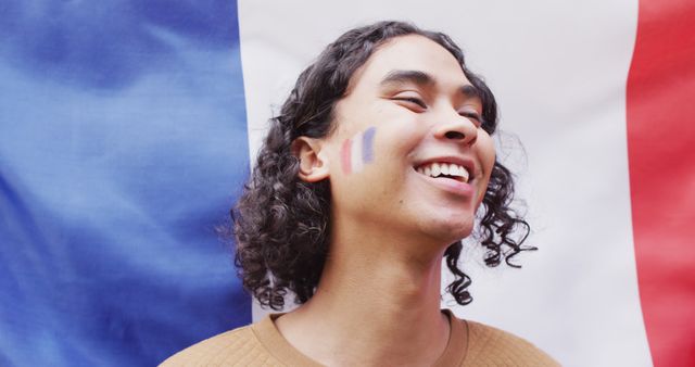Portrait of happy biracial man with flag of france in background and on cheek - Download Free Stock Photos Pikwizard.com