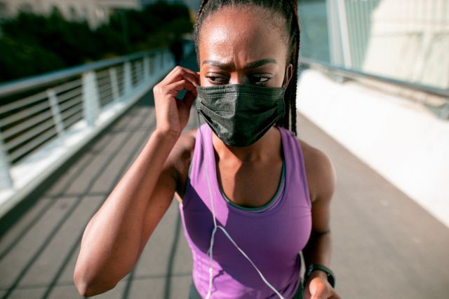 Fit african american woman wearing face mask, exercising in city - Download Free Stock Photos Pikwizard.com