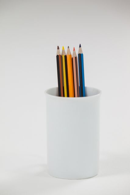 Colored pencils kept in cup - Download Free Stock Photos Pikwizard.com