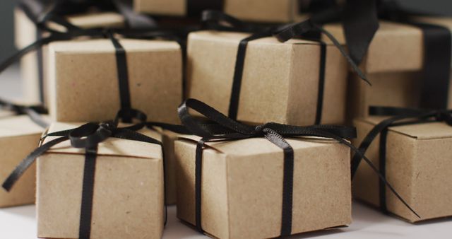 Brown gift boxes with black ribbons on dark grey background - Download Free Stock Photos Pikwizard.com