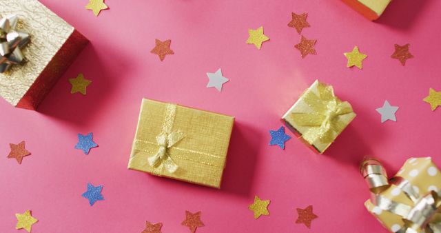Image of wrapped presents and colourful stars on pink background - Download Free Stock Photos Pikwizard.com