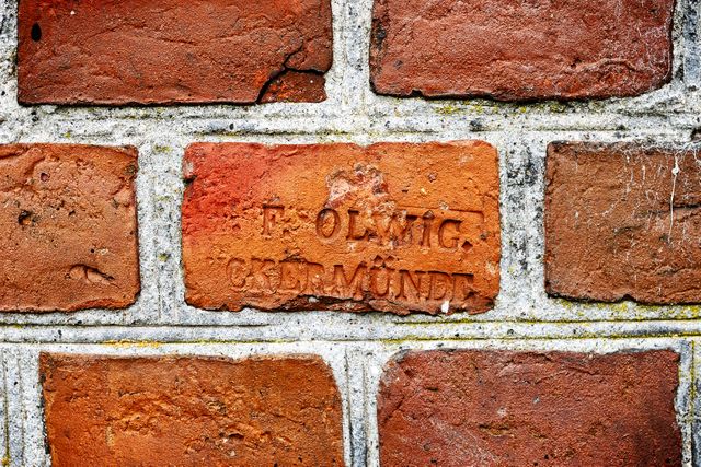 a brick wall with the word olemic on it - Download Free Stock Photos Pikwizard.com