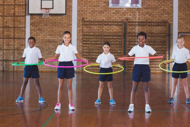 School kids playing with hula hoop in in basketball court - Download Free Stock Photos Pikwizard.com