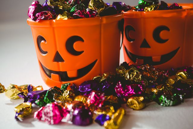 Close up of orange buckets with multicolored chocolates - Download Free Stock Photos Pikwizard.com
