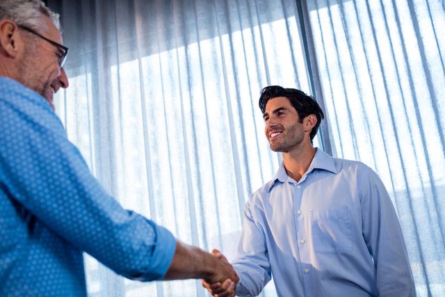 Two businessmen giving a handshake - Download Free Stock Photos Pikwizard.com