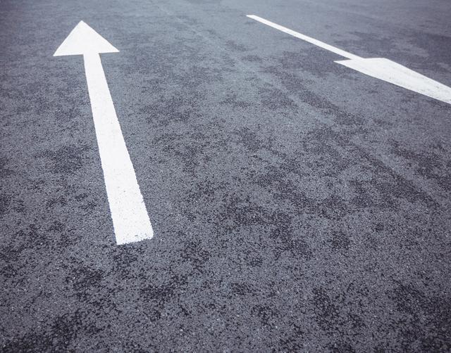 Two opposite direction arrows on road surface - Download Free Stock Photos Pikwizard.com