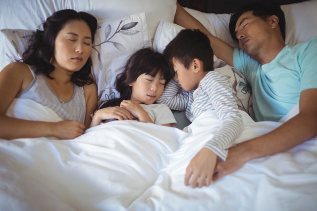 Family sleeping on bed in the bed room - Download Free Stock Photos Pikwizard.com