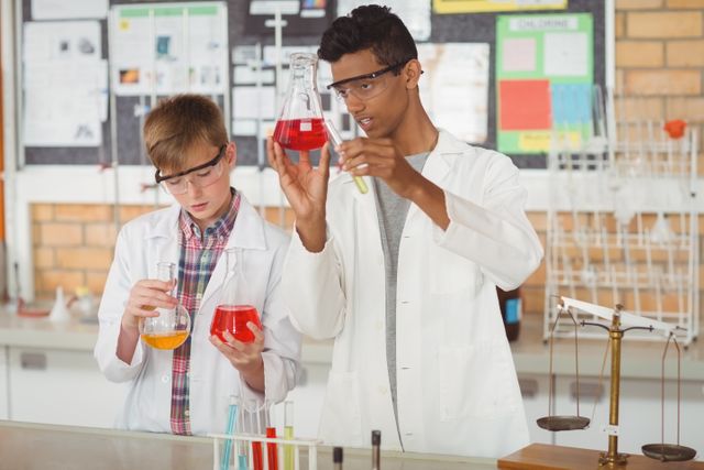 Attentive schoolboys doing a chemical experiment in laboratory - Download Free Stock Photos Pikwizard.com