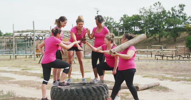 Diverse group of happy female friends and trainer cross training outdoors, teaming up. Female fitness, challenge and healthy lifestyle.