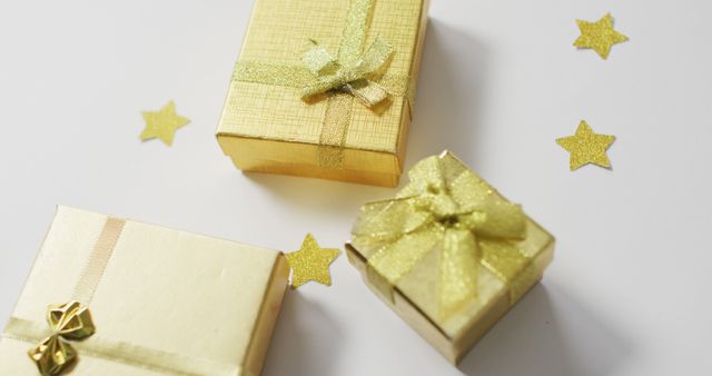 Image of gold christmas presents and stars on white background - Download Free Stock Photos Pikwizard.com