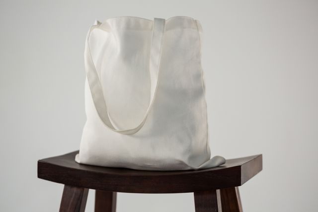 White bag on wooden stool - Download Free Stock Photos Pikwizard.com