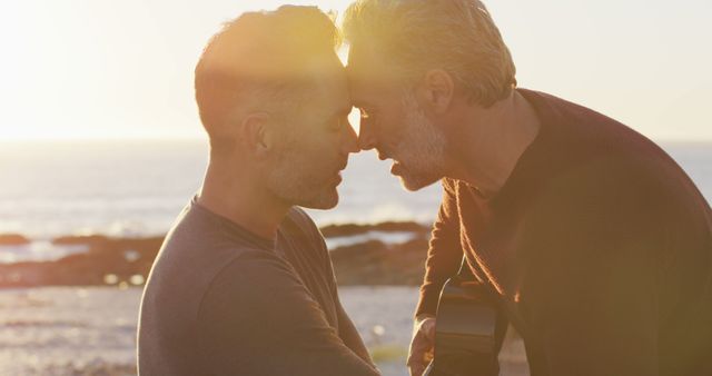 Happy caucasian gay male couple sitting on car playing guitar and kissing at the beach - Download Free Stock Photos Pikwizard.com