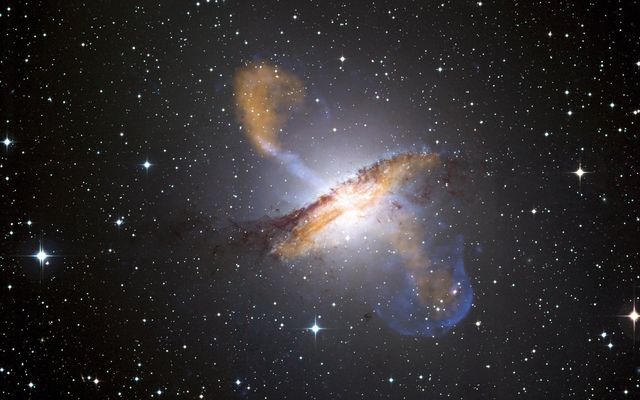 a galaxy with a large black hole in the center - Download Free Stock Photos Pikwizard.com