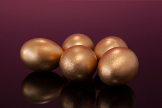 Golden Easter eggs on colored background - Download Free Stock Photos Pikwizard.com