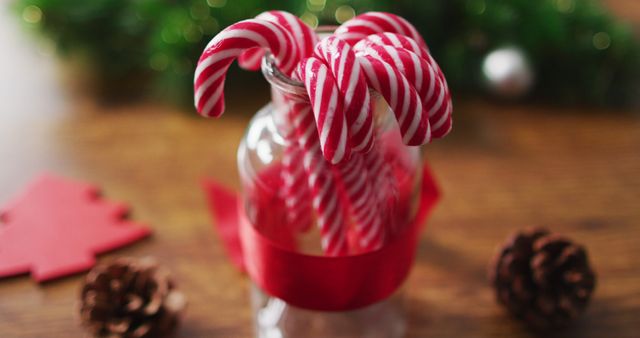 Image of christmas decorations with pine cones and candy canes at home - Download Free Stock Photos Pikwizard.com
