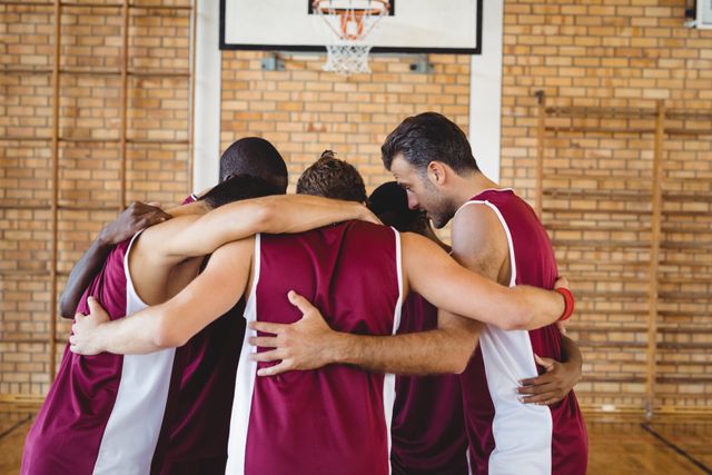 Basketball players forming a huddle in the court 