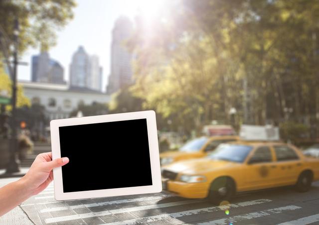 hand with tablet in front of taxis - Download Free Stock Photos Pikwizard.com
