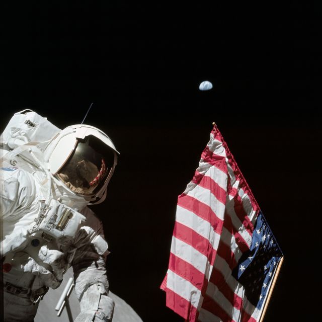 AS17-134-20384 (7-19 Dec. 1972) --- Scientist-astronaut Harrison H. Schmitt, lunar module pilot, is photographed next to the deployed United States flag during lunar surface extravehicular activity (EVA) at the Taurus-Littrow landing site. The highest part of the flag appears to point toward our planet Earth in the distant background. This picture was taken by astronaut Eugene A. Cernan, Apollo 17 commander. While astronauts Cernan and Schmitt descended in the Lunar Module (LM) to explore the moon, astronaut Ronald E. Evans, command module pilot, remained with the Command and Service Modules (CSM) in lunar orbit.