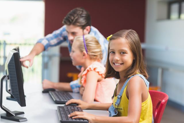 Schoolgirl using computer in classroom - Download Free Stock Photos Pikwizard.com