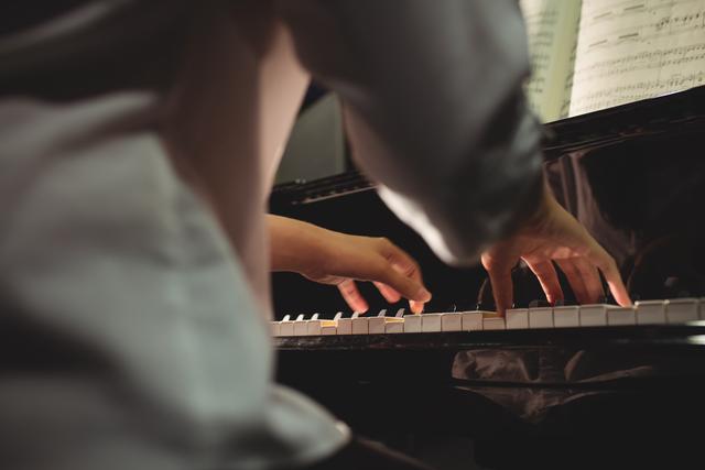 Mid-section of female student playing piano - Download Free Stock Photos Pikwizard.com