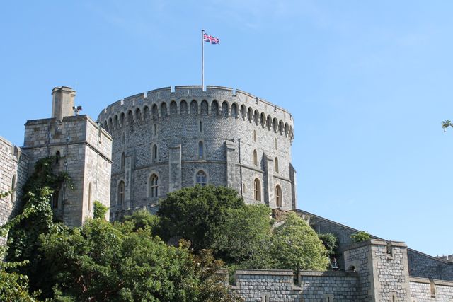 Gray Concrete Castle With Flag on Top Under Blue Sky - Download Free Stock Photos Pikwizard.com