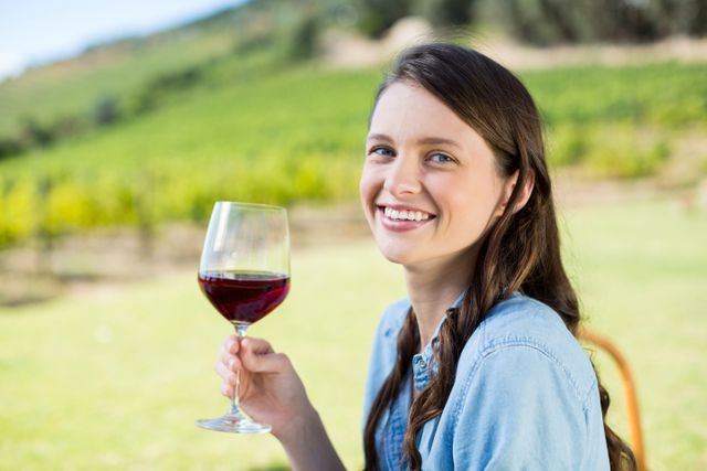 Portrait of smiling woman holding red wine - Download Free Stock Photos Pikwizard.com
