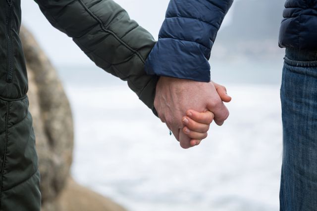Close-up of couple holding hands on the beach - Download Free Stock Photos Pikwizard.com