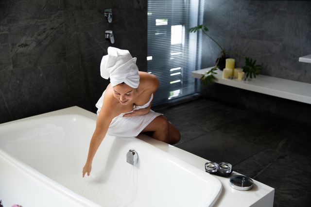 Caucasian woman preparing bath in hotel - Download Free Stock Photos Pikwizard.com