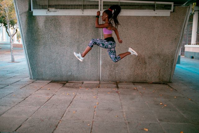 Fit african american woman exercising in city under bridge - Download Free Stock Photos Pikwizard.com