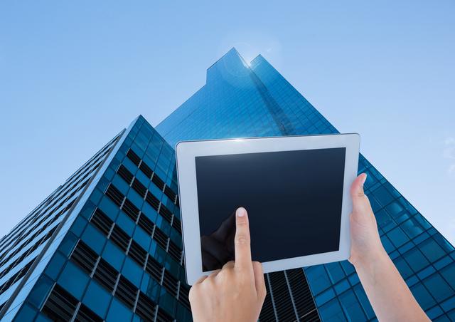 Holding tablet with skyscraper background - Download Free Stock Photos Pikwizard.com