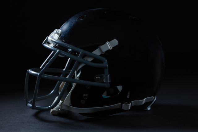 American football head gear on a black background - Download Free Stock Photos Pikwizard.com