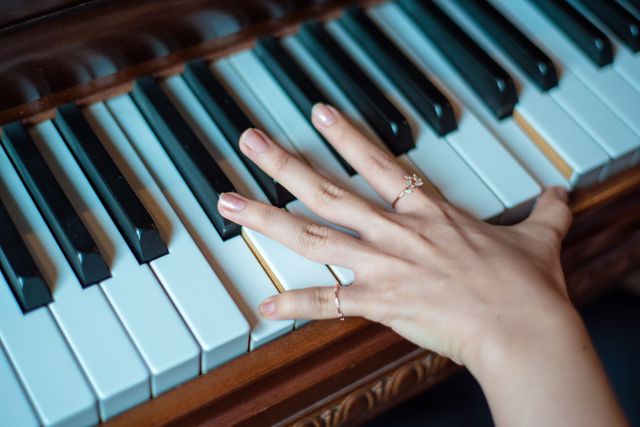 Brown Wooden Piano Used by a Person Using 2 Fingers - Download Free Stock Photos Pikwizard.com