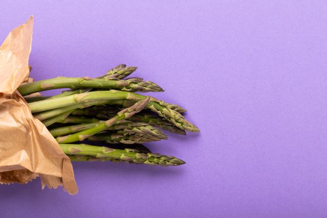 Overhead view of asparagus on purple background, copy space - Download Free Stock Photos Pikwizard.com