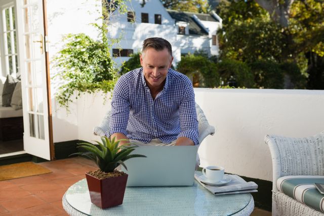 Businessman using laptop in outdoor cafe - Download Free Stock Photos Pikwizard.com