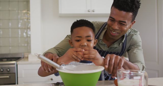 African american father teaching his son how to crack eggs while baking in the kitchen at home - Download Free Stock Photos Pikwizard.com