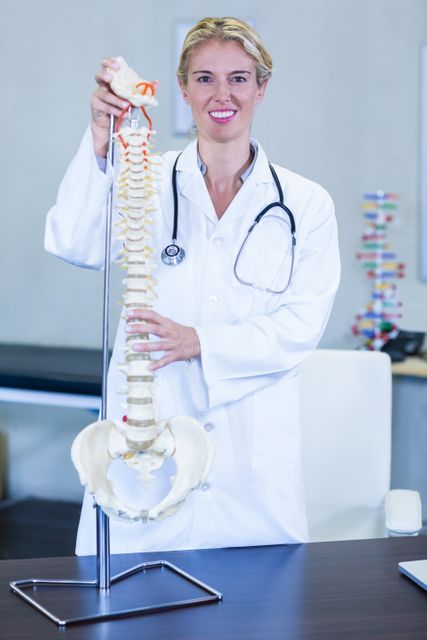 Physiotherapist holding a spine model - Download Free Stock Photos Pikwizard.com