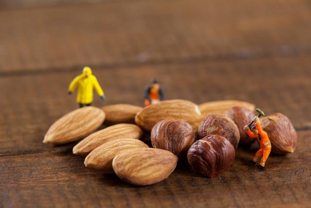 Miniature workers working with almonds and nuts - Download Free Stock Photos Pikwizard.com