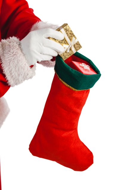 Santa claus putting presents in christmas stockings - Download Free Stock Photos Pikwizard.com