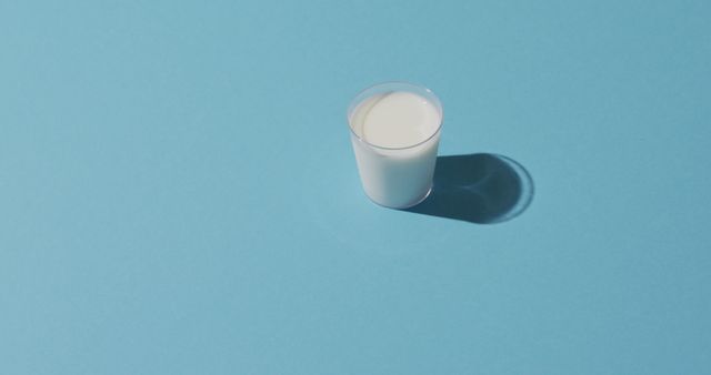 Image of glass of fresh milk over blue background - Download Free Stock Photos Pikwizard.com