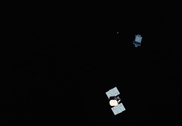 View of Astronaut Nelson using MMU to examine Solar Maximum Mission Satellite - Download Free Stock Photos Pikwizard.com