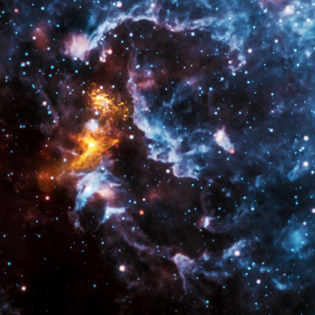 In this image of PSR B1509-58 about 170,000 light-years from Earth, X-rays from NASA Chandra in gold are seen along with infrared data from NASA Wide-field Infrared Survey Explorer WISE telescope in red, green and blue.