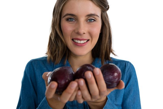 Portrait of young woman holding plums - Download Free Stock Photos Pikwizard.com