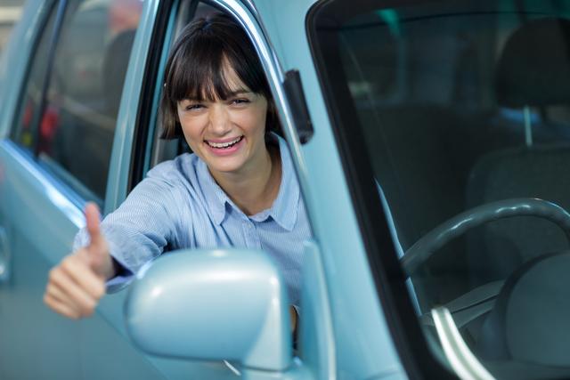 Customer showing thumbs up while driving a car - Download Free Stock Photos Pikwizard.com