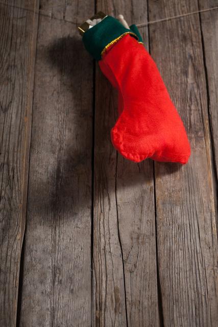 Christmas stocking with present box hanging against wooden wall - Download Free Stock Photos Pikwizard.com