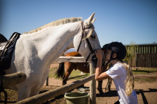 Girl kissing the white horse in the ranch - Download Free Stock Photos Pikwizard.com