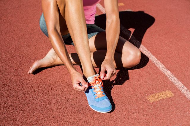 Female athlete tying her running shoes - Download Free Stock Photos Pikwizard.com