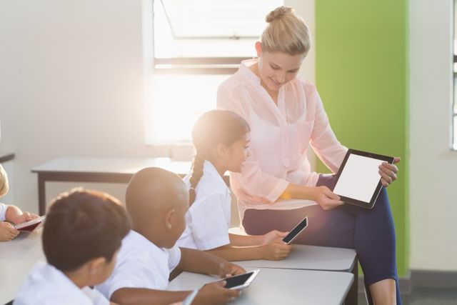 Teacher teaching kids on digital tablet - Download Free Stock Photos Pikwizard.com