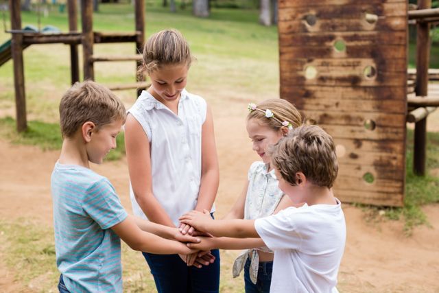 Kids forming hand stack in park - Download Free Stock Photos Pikwizard.com