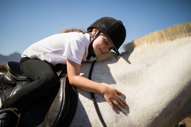 Smiling girl embracing the white horse in the ranch - Download Free Stock Photos Pikwizard.com