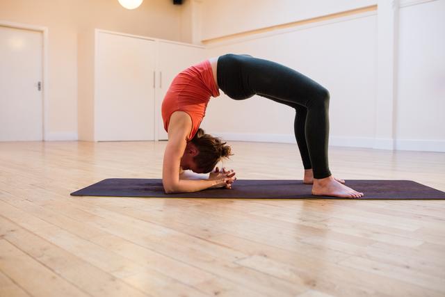 African american mid adult woman practicing yoga during online